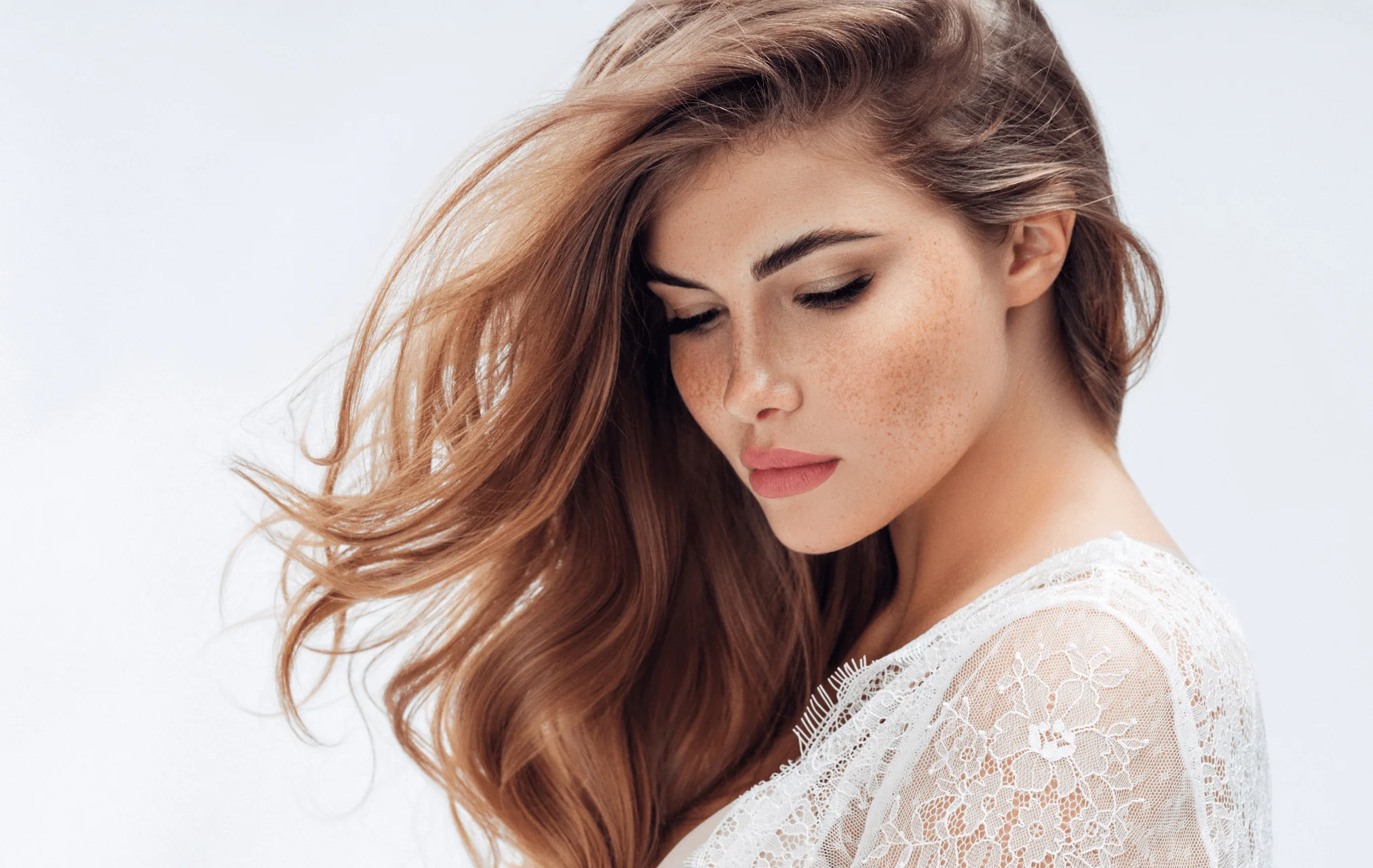Woman with long auburn hair and natural-looking skin