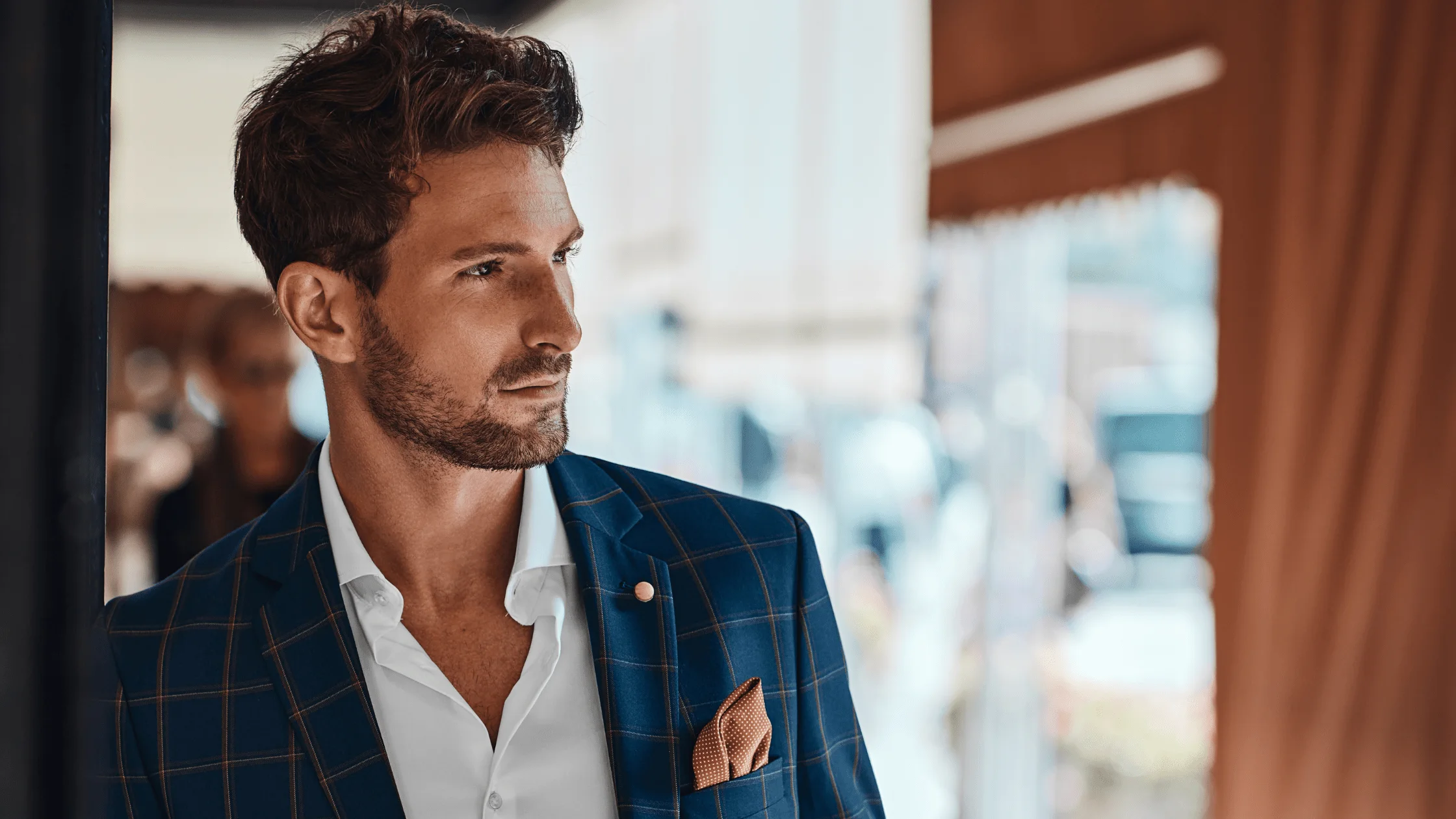 Man with a groomed beard wearing a tailored jacket